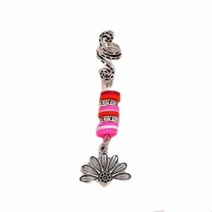 Detail of bohemian spiral hair clip with multicolored beads and silver floral charm