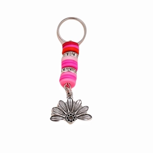Detail of bohemian keychain with pink beads, rhinestone spacers and metal lotus charm