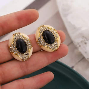 Retro S925 oval earrings with black resin center and crystal halo on gold-tone base