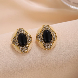 Macro shot of vintage oval earrings with black resin center and sparkling pavé crystals
