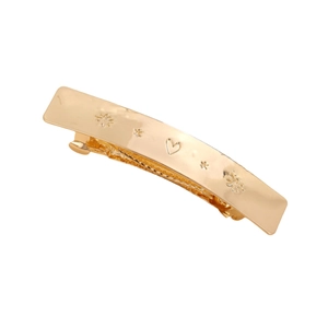 Barrette dorée polie avec motifs d'étoiles et de cœurs sur fond blanc pur