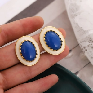 Boucles d'oreilles vintage ovales avec pierres bleu foncé et montures dorées