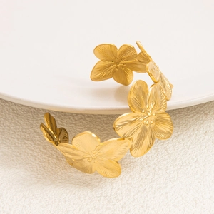 Detail of 18K gold plated vintage open bangle with engraved floral petal textures