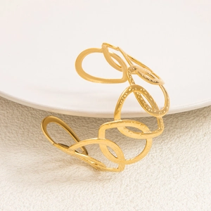Detailed view of the 18K gold-plated cutout open cuff with vintage hammered textures