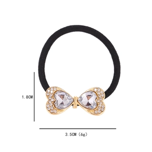 Sparkling rhinestone bow hair tie with heart stones and size dimensions in 1.8cm x 3.5cm