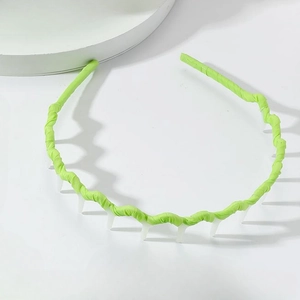 Detail of neon green wavy headband with white anti-slip teeth for secure hair styling