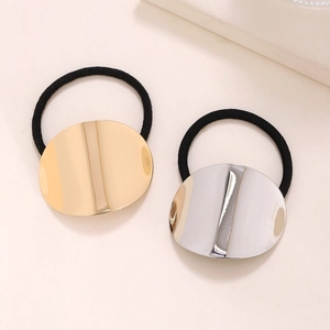 Minimalist oval gold and silver hair ties with polished metallic surface and elastic bands