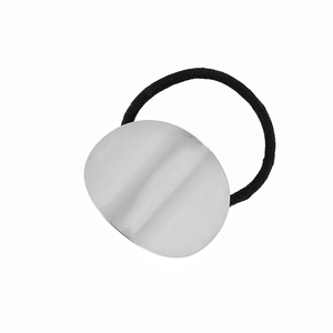 Detail view of high-elastic black hair tie with oval silver polished metal plate