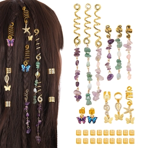 Detail view of gold butterfly and star hair charms with amethyst and green aventurine stones