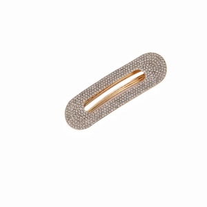 Minimalistische Haarspange aus Goldmetall mit weißen Strasssteinen auf Weiß