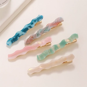 5-piece set of wavy acetate hair clips in marbled colors with gold metal bases