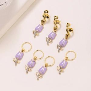 Golden alloy African braid hair rings with purple tulip charms and sparkling rhinestones