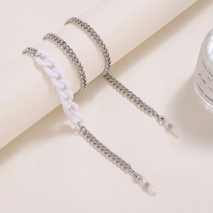 Fashionable acrylic resin and silver metal chain for glasses or face masks on a white stand