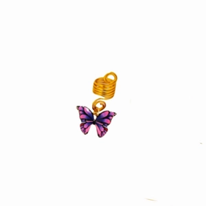 Detailed view of golden spiral hair coil featuring a purple butterfly charm for braids
