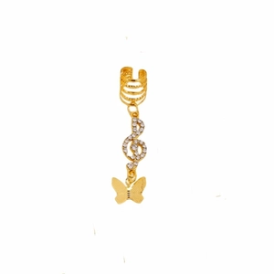 Detail of gold dreadlock cuff with treble clef charm and rhinestone butterfly pendant