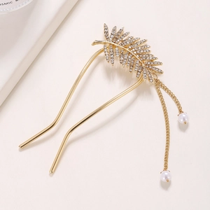 Détail d'épingle à cheveux en U dorée, motif feuille, strass incrustés et pompons perles