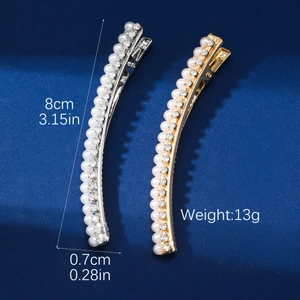 Detailed view of 8cm pearl and rhinestone hair clips in gold and silver finish