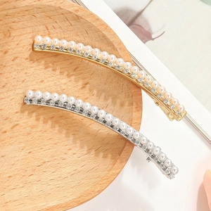 Elegant pearl and rhinestone hair clip in gold finish with curved metal design