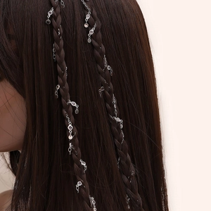 Y2K style silver hair chain with rhinestones woven into a long dark brown braid