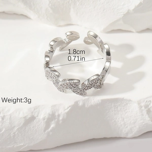 Detail view of silver wave ring with pavé-set zircons and adjustable open band