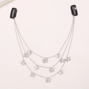 Detail of silver multi-layered butterfly hair chain with metallic charms and black BB clips