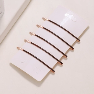 Set of 6 minimalist hair clips in coffee and rose gold finish on a display card