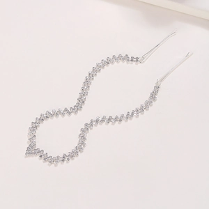Elegant silver bridal hair chain with sparkling rhinestones and long tassels on white background