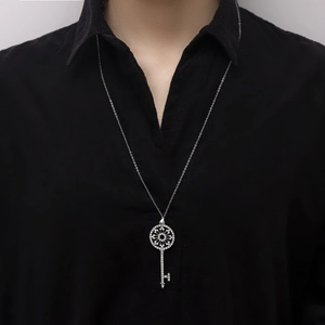 Macro shot of a sparkling vintage key pendant with zircon inlays on an O-chain necklace