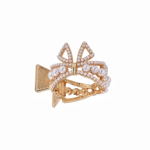 Elegant gold alloy hair claw clip with bow-shaped pearl embellishments on white background