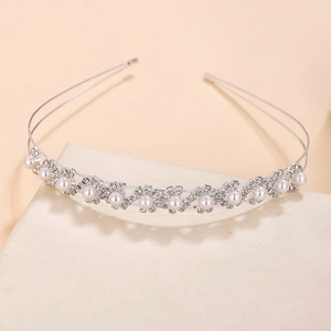 Elegant bridal headband with sparkling rhinestones and white pearls on a silver metal frame