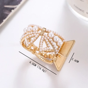 Elegant gold alloy hair claw with white pearls in a delicate bow design for women