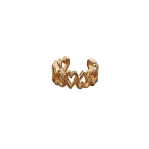 Macro detail of gold heart-shaped hollow earrings with a polished finish and open design