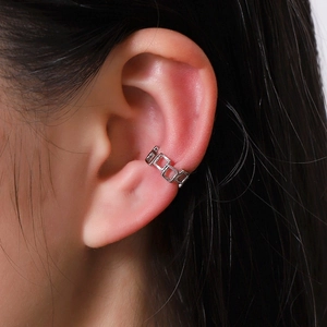 Minimalist silver U-shaped square hollow ear cuff worn on the cartilage by a model