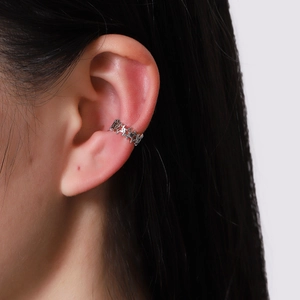 Minimalist silver U-shaped star ear cuff clip for non-pierced ears on female model