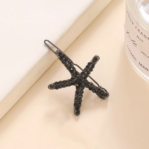 Vue détaillée de la pince à cheveux étoile de mer avec strass noirs et base en métal