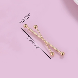 Detailed view of two gold metal hair pins with size labels 5.6cm and 1cm width