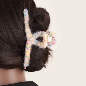 Sweet multi-colored wool yarn wrapped hair claw clip for women shown on a model