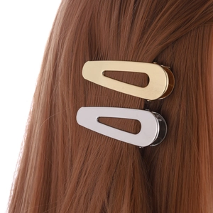 Hollow teardrop hair clips in gold and silver finish shown on brown hair