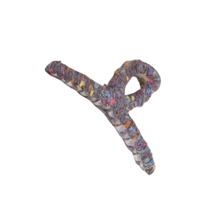 Detail of grey wool knit claw clip featuring colorful fiber specks and metal spring mechanism