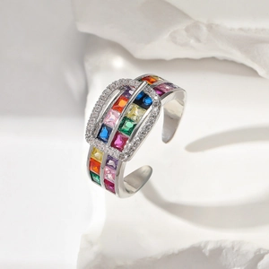 Macro shot of silver belt-style ring featuring vibrant rainbow-colored square gemstones