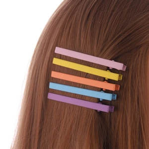 Five candy-colored matte metal hair clips shown on hair for a minimalist look