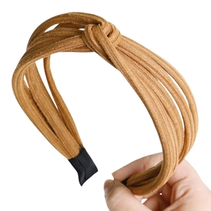 Detail of the mustard yellow ribbed knit headband showing the twist knot and texture