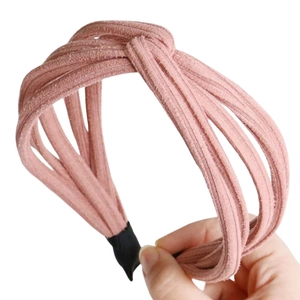 Close-up of pink knotted wide headband with soft textured fabric and protective ends