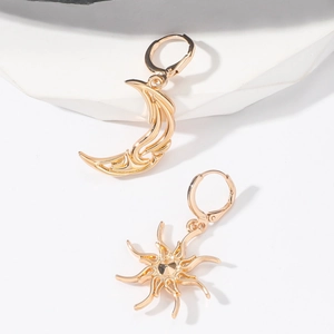 Minimalist gold sun and moon mismatched earrings with a polished bohemian celestial design