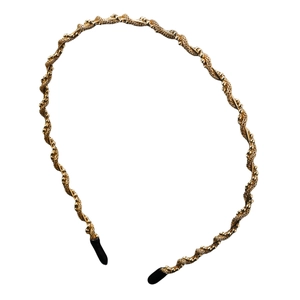 Minimalist golden twisted metal headband with comfortable black protective end caps