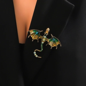 Vintage dragon brooch with green enamel and crystals pinned on a black suit lapel