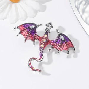 Close-up of vintage dragon brooch with purple enamel and sparkling crystals