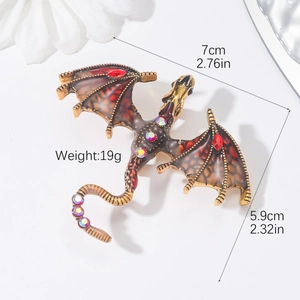 Detailed view of vintage dragon brooch with colorful rhinestones and enamel wings