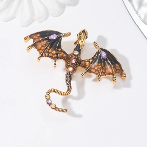Detailed macro shot of vintage dragon brooch with black enamel and purple rhinestones
