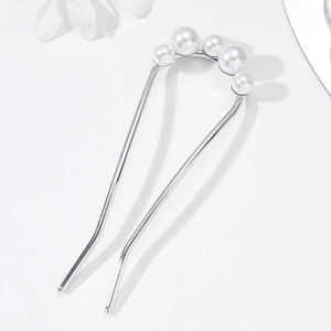 Detail view of U-shaped hair pin featuring elegant white pearls on silver alloy metal base